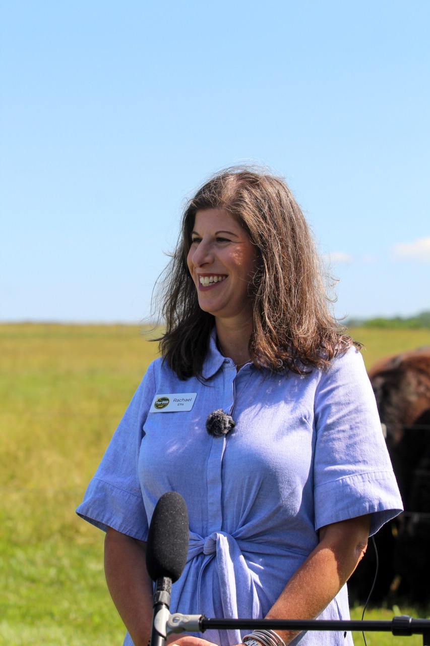 Home Incoming CEO Rachael Ellis stands on a farm we partner with through Harvesting Hope.